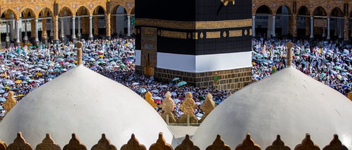 Crowds of pilgrims gather around the Kaaba in Mecca, Saudi Arabia during a religious event.