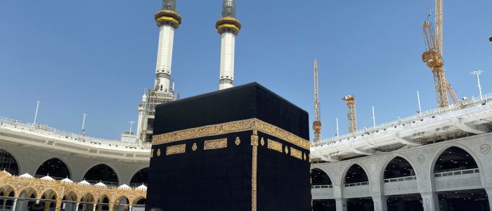 Crowd of worshippers in Mecca surrounding the Kaaba at the Grand Mosque during pilgrimage.