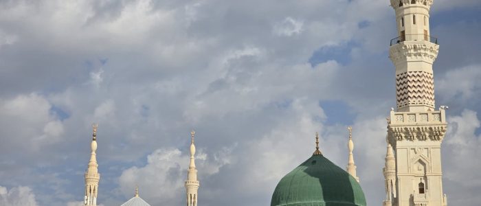 Stunning view of Prophet's Mosque showcasing the iconic Green Dome against cloudy skies.